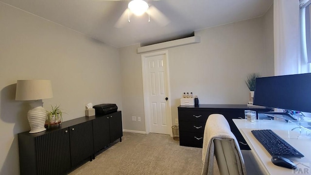 office with baseboards, light colored carpet, and a ceiling fan