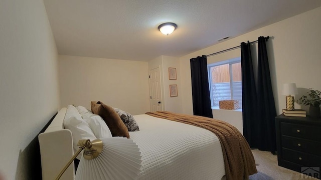 bedroom with visible vents and carpet