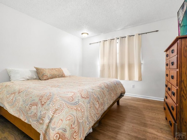 213 Starlite Dr, Pueblo, CO 81005 - bedroom featuring wood finished floors and a textured ceiling