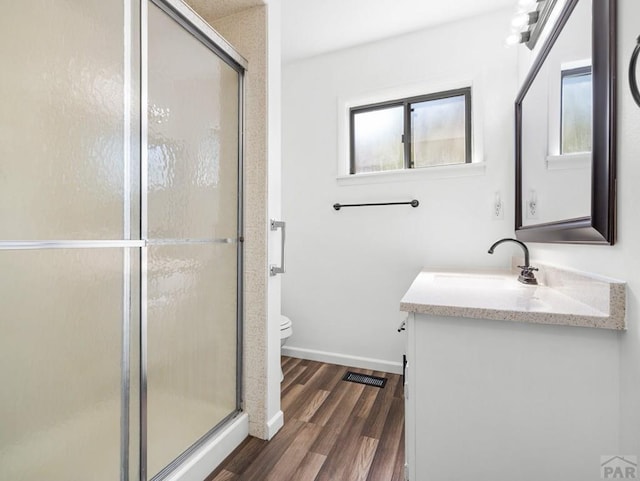 213 Starlite Dr, Pueblo, CO 81005 - bathroom featuring vanity, wood finished floors, and a shower stall