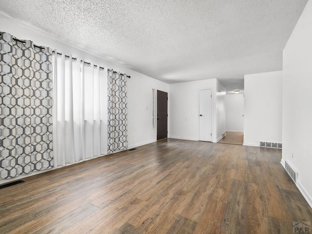 213 Starlite Dr, Pueblo, CO 81005 - unfurnished room featuring wood finished floors and a textured ceiling