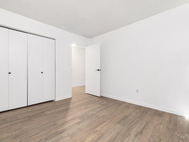 213 Starlite Dr, Pueblo, CO 81005 - unfurnished bedroom featuring wood finished floors and a closet