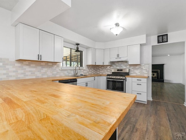 213 Starlite Dr, Pueblo, CO 81005 - kitchen with butcher block counters, appliances with stainless steel finishes, dark wood finished floors, and white cabinets