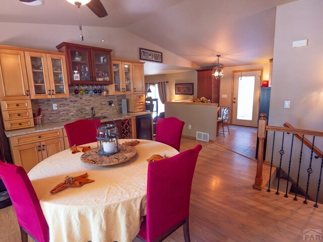 dining area featuring lofted ceiling, a wealth of natural light, light wood finished floors, and visible vents