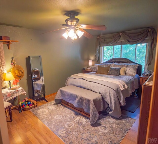 bedroom featuring ceiling fan and wood finished floors