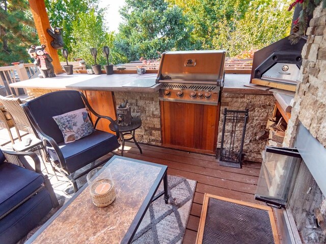 deck featuring area for grilling and an outdoor kitchen