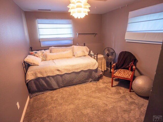 bedroom with carpet floors and baseboards