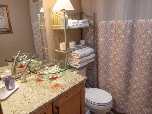 full bathroom with vanity and toilet