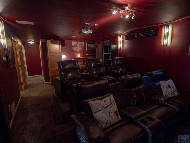 carpeted home theater room featuring baseboards