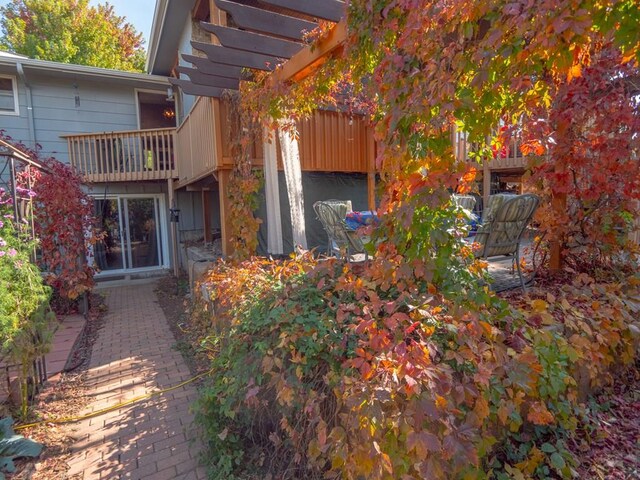 view of side of home with a balcony, a pergola, and a patio