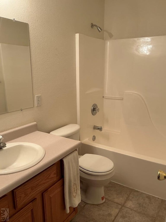 bathroom featuring toilet, tile patterned flooring, shower / washtub combination, and vanity