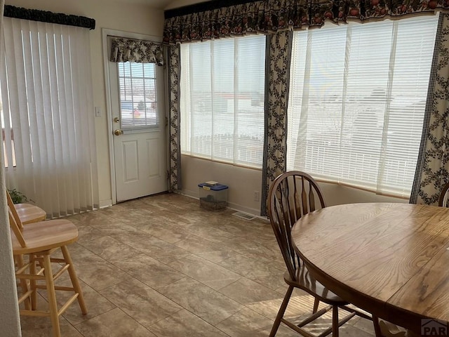 dining room featuring visible vents, baseboards, and light tile patterned flooring