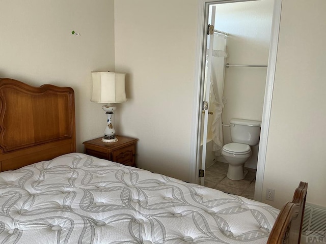 tiled bedroom with ensuite bathroom