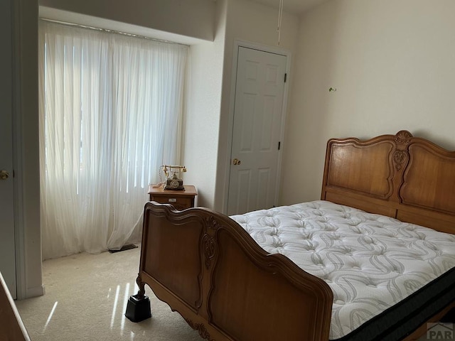 bedroom featuring light colored carpet