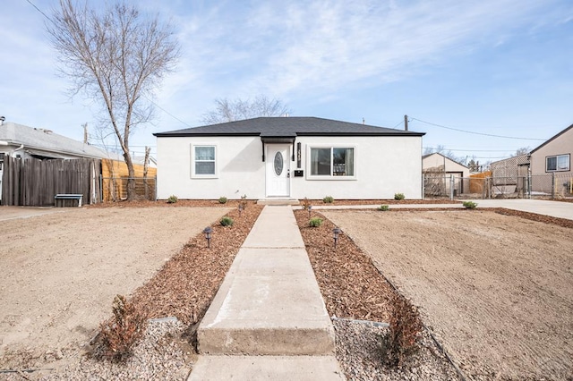 view of front of home with fence and stucco siding