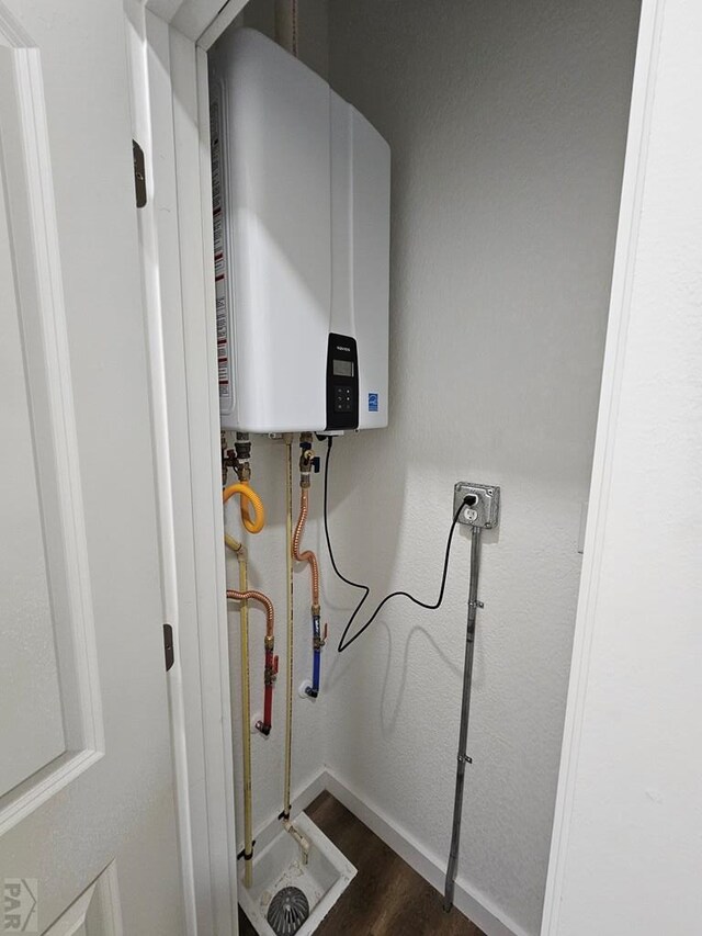 utility room with tankless water heater