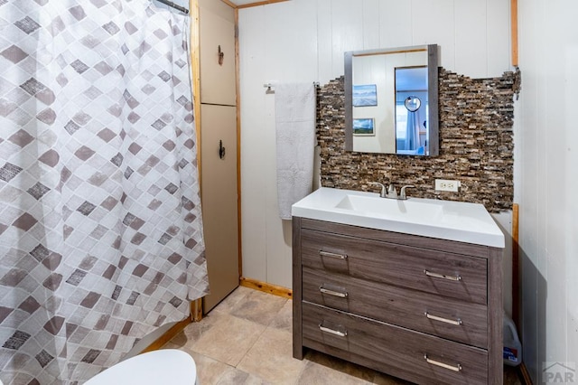 full bathroom with a shower with shower curtain, tile patterned floors, toilet, and vanity