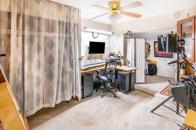 home office with light carpet and a ceiling fan