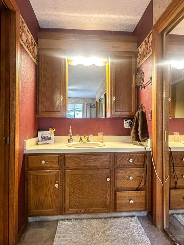 bathroom featuring a textured ceiling and vanity