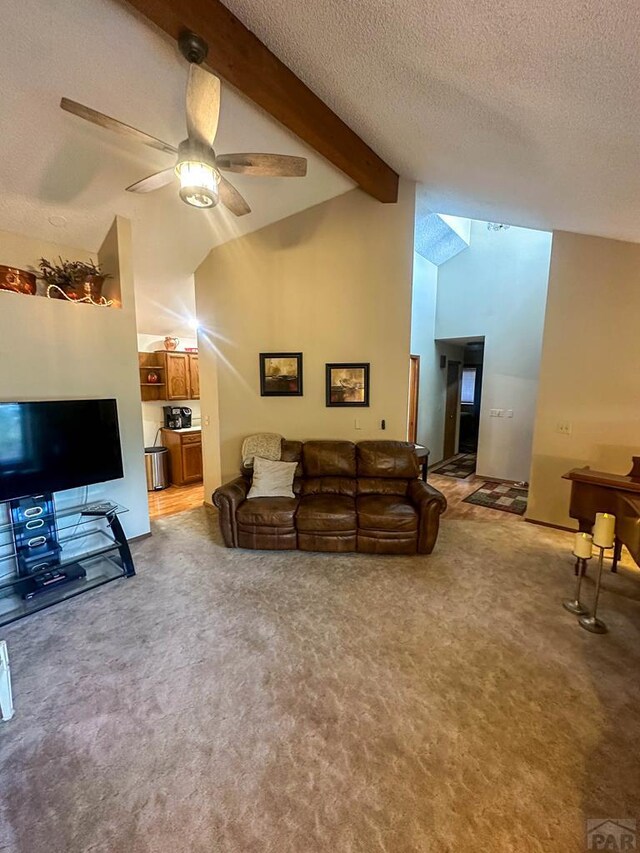 living room with ceiling fan, a textured ceiling, high vaulted ceiling, light carpet, and beam ceiling