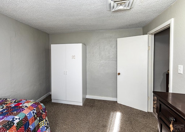 bedroom featuring a textured ceiling and a textured wall