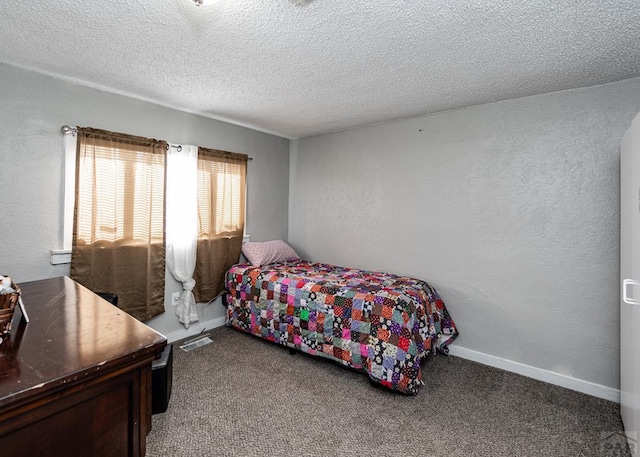 bedroom featuring carpet floors, visible vents, a textured wall, a textured ceiling, and baseboards