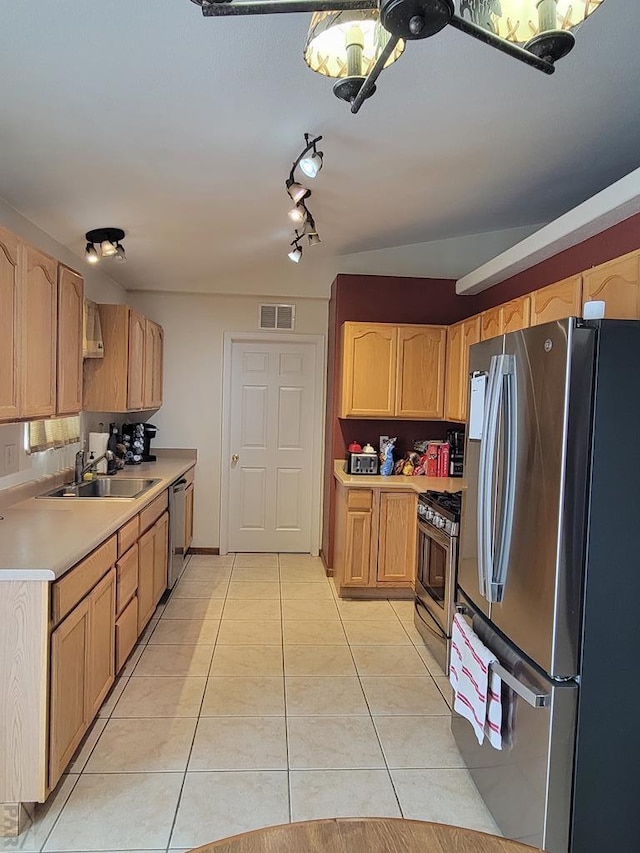 kitchen with light tile patterned flooring, stainless steel appliances, a sink, visible vents, and light countertops