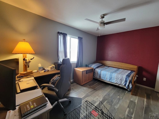 bedroom featuring dark wood-style floors, baseboards, and a ceiling fan