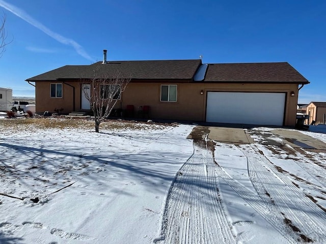 view of front of property with an attached garage and stucco siding