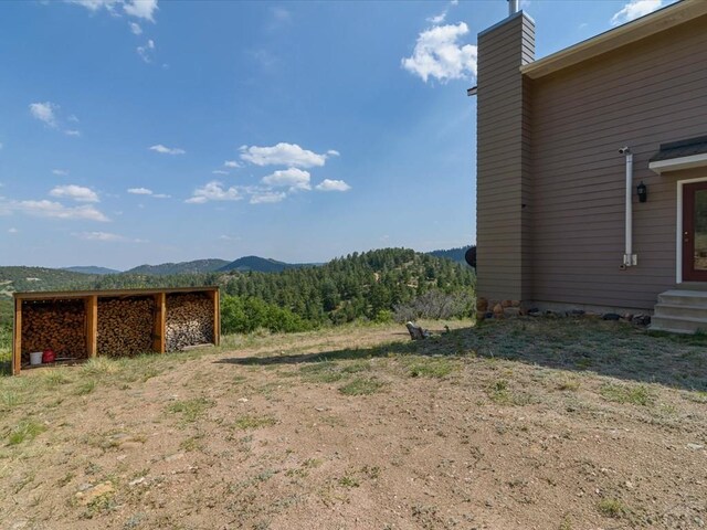 view of yard with entry steps and a mountain view