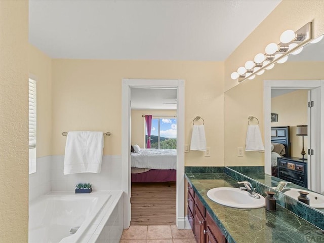 ensuite bathroom featuring a bath, tile patterned flooring, vanity, and ensuite bathroom