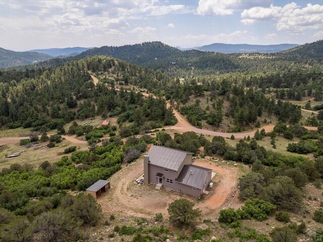 birds eye view of property featuring a mountain view and a forest view