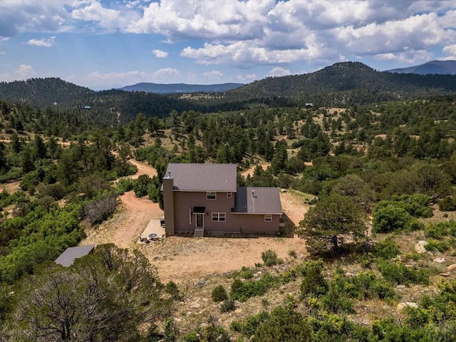 aerial view featuring a view of trees and a mountain view