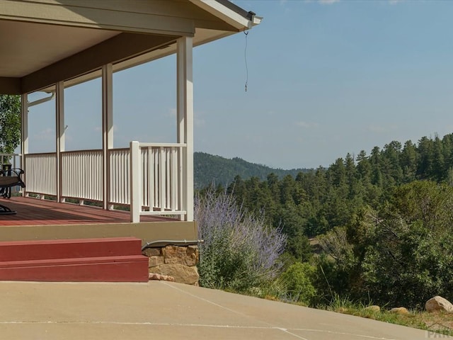 exterior space featuring a wooded view