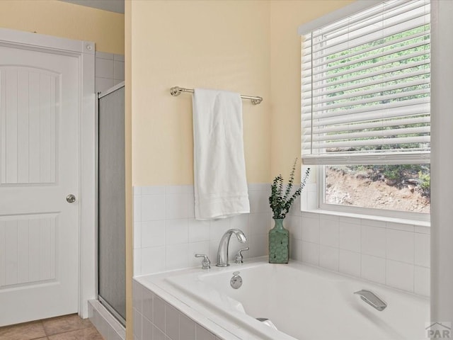 full bathroom with tile patterned flooring, a shower stall, and a bath