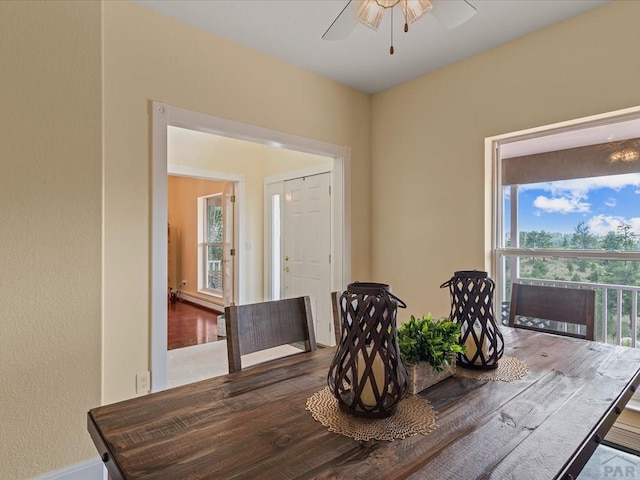 dining room with ceiling fan and wood finished floors