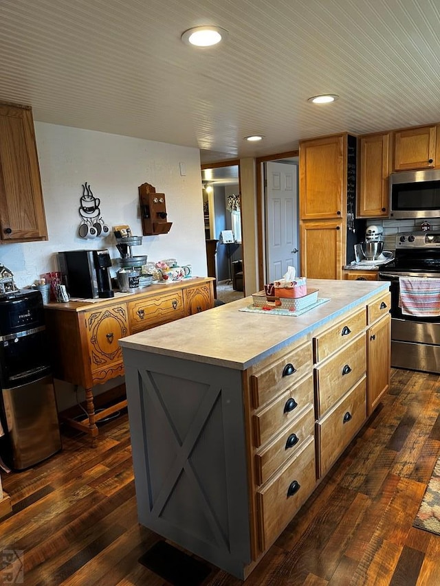 25433 County Rd 25, La Junta, CO 81050 - kitchen with stainless steel appliances, a kitchen island, light countertops, dark wood-type flooring, and recessed lighting