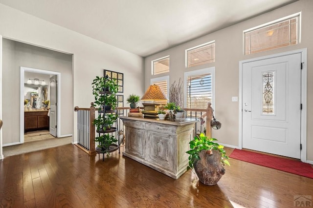 foyer featuring baseboards and hardwood / wood-style flooring
