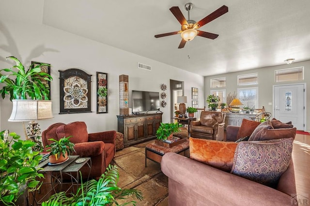 living room with visible vents and ceiling fan