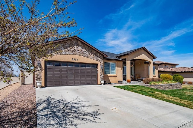 ranch-style home featuring an attached garage, concrete driveway, stucco siding, and a front lawn