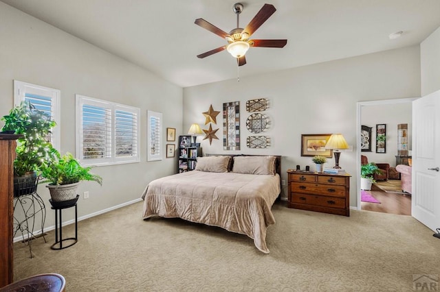 carpeted bedroom featuring baseboards and ceiling fan