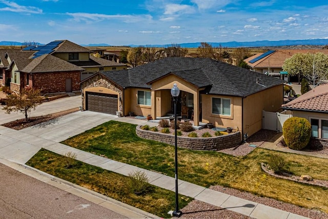 ranch-style house with stucco siding, a front yard, fence, a gate, and concrete driveway