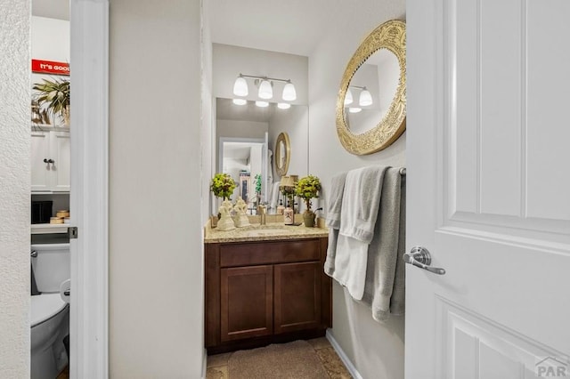 bathroom with vanity and toilet