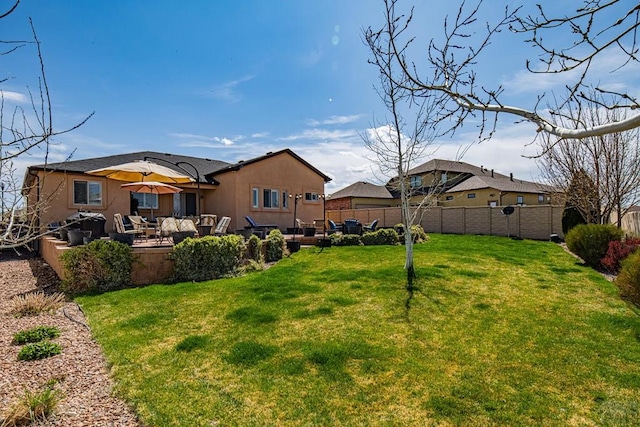 view of yard featuring a patio area and a fenced backyard