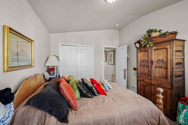 bedroom with visible vents, a closet, and lofted ceiling