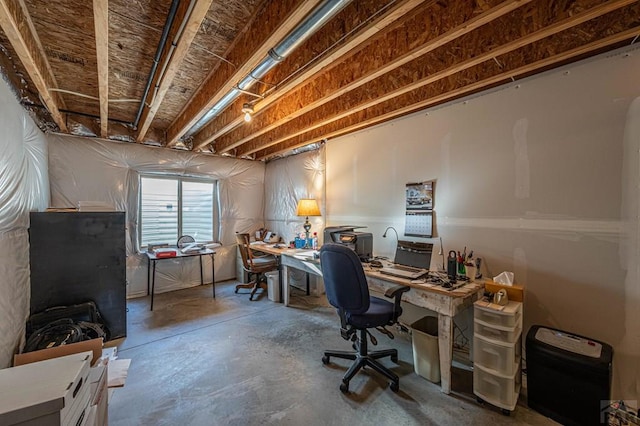 office area with unfinished concrete flooring