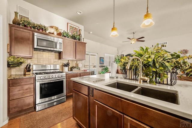 kitchen with backsplash, visible vents, ceiling fan, stainless steel appliances, and pendant lighting