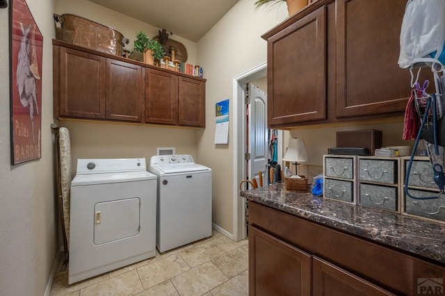 laundry area featuring cabinet space, light tile patterned floors, baseboards, and washing machine and dryer