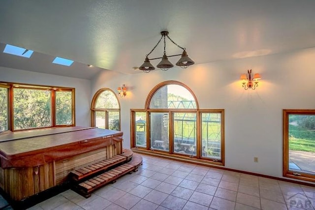 5207 N Creek Rd, Beulah, CO 81023 - playroom featuring light tile patterned floors, healthy amount of natural light, a skylight, vaulted ceiling, and baseboards