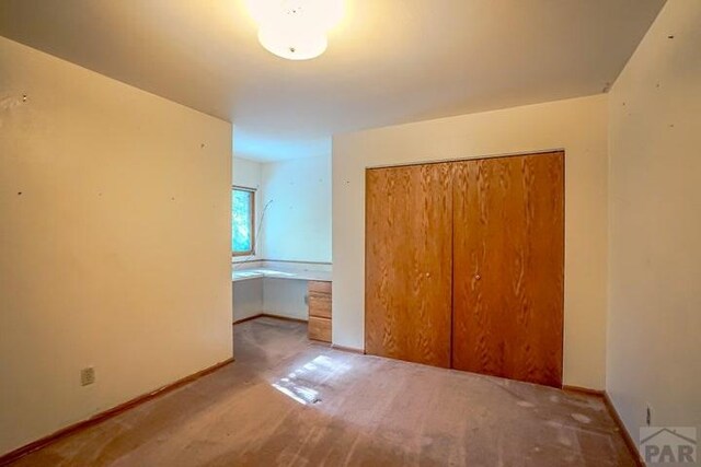 5207 N Creek Rd, Beulah, CO 81023 - unfurnished bedroom featuring a closet, carpet flooring, and baseboards